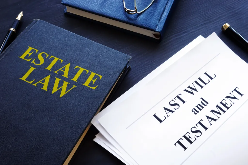 Estate law book and a "Last Will and Testament" document on a desk, highlighting the legal complexities of writing a Will in Australia.